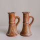Set of two terracotta candle holders.