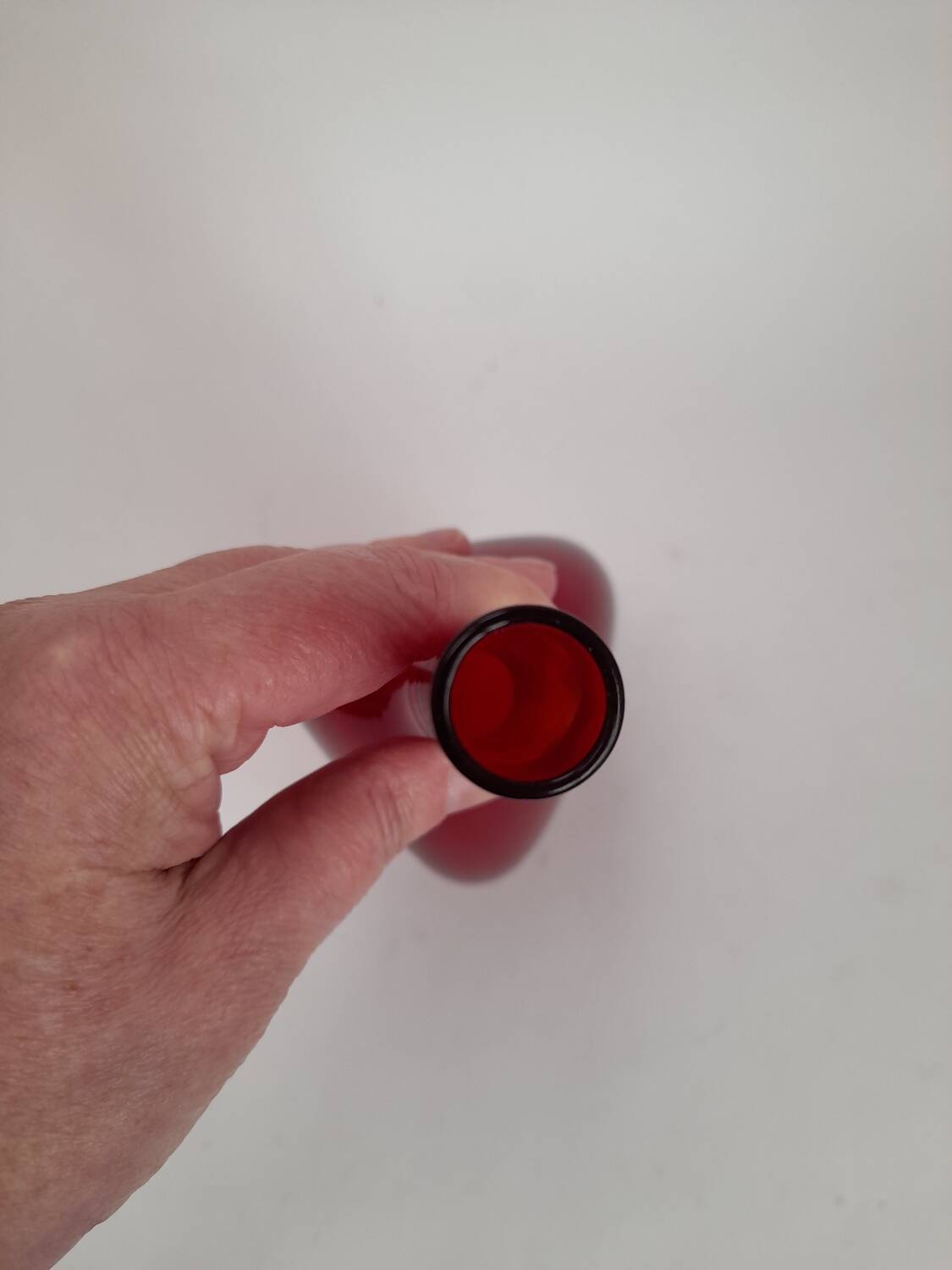 Triangular red glass vase by Gunnar Ander for Elme Glasbrück.