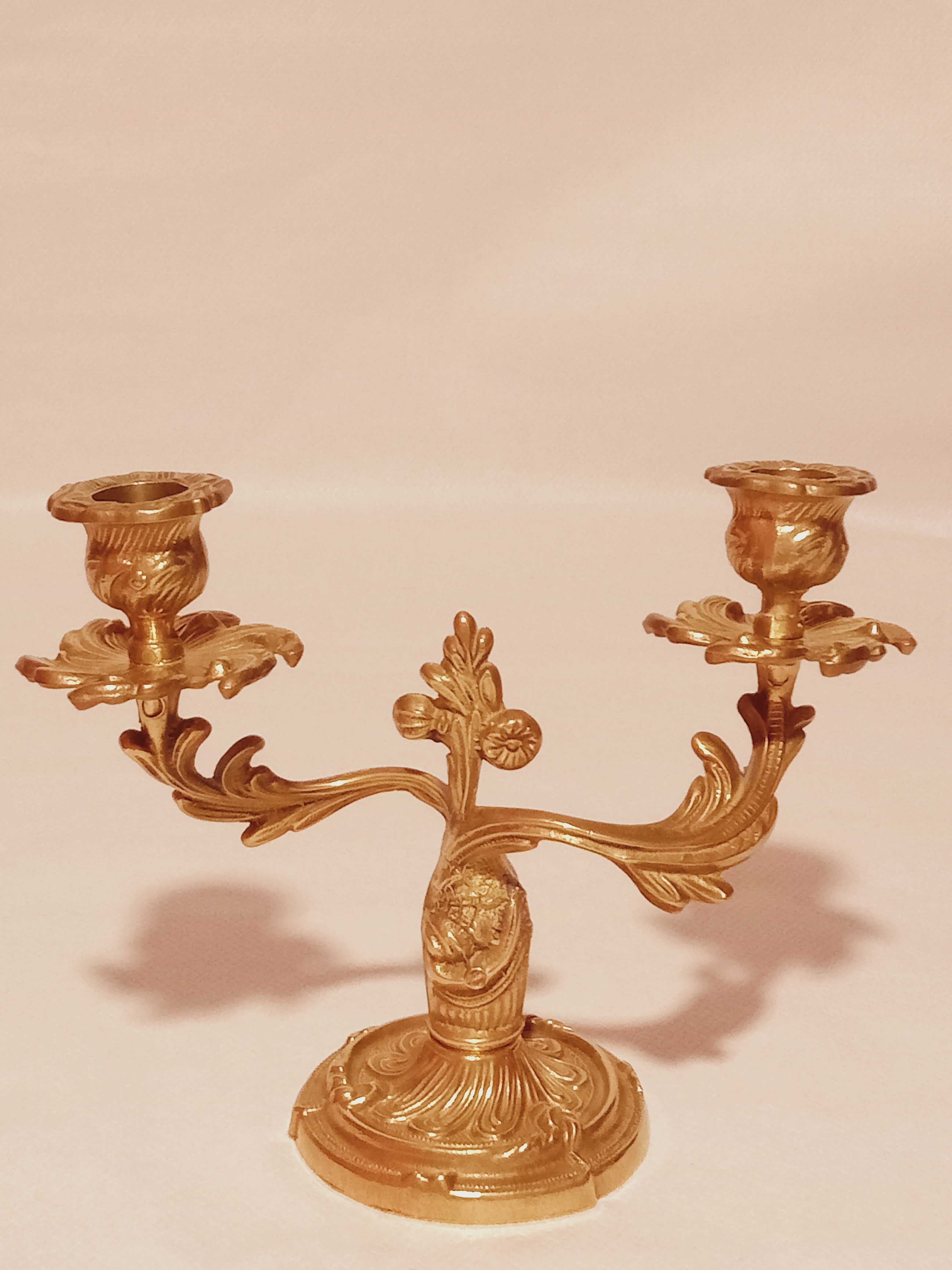 Old candle holder in gilded bronze