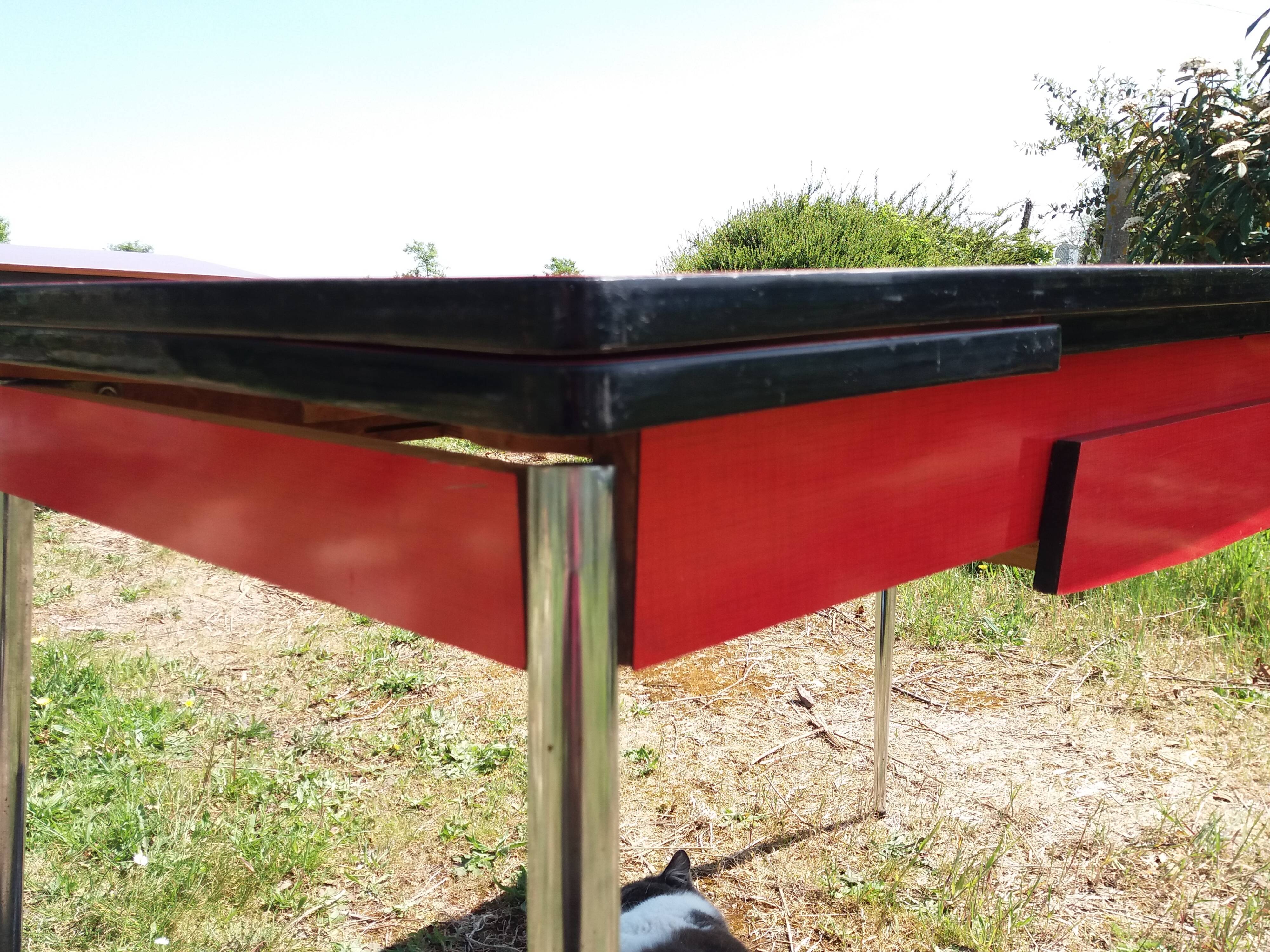 Dining table with red formica extensions