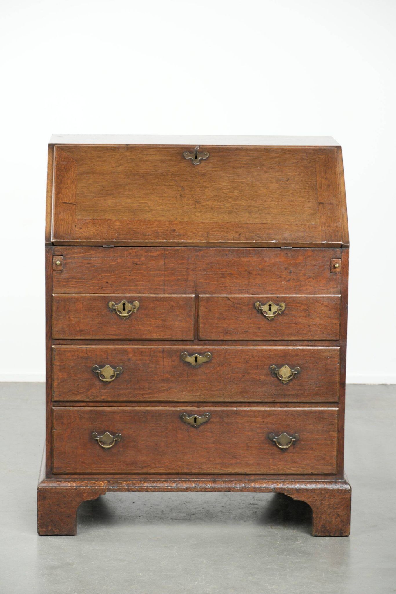 Antique English oak secretary from the 18th century with a stepped interior