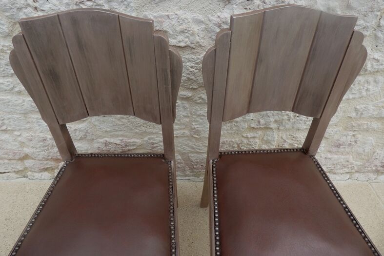 Two restyled leather-style chairs with nails