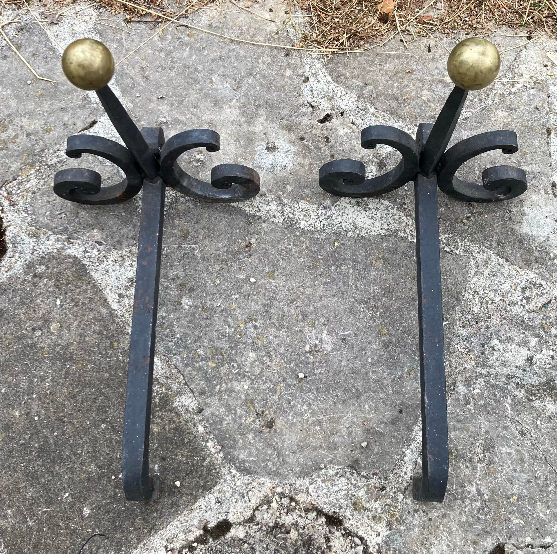 Massive wrought iron chenets from the 19th century topped with brass balls.