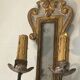 Pair of wall sconces in carved wood and silvered and gilded patinated metal with a central mirror.