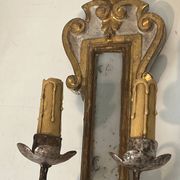 Pair of wall sconces in carved wood and silvered and gilded patinated metal with a central mirror.