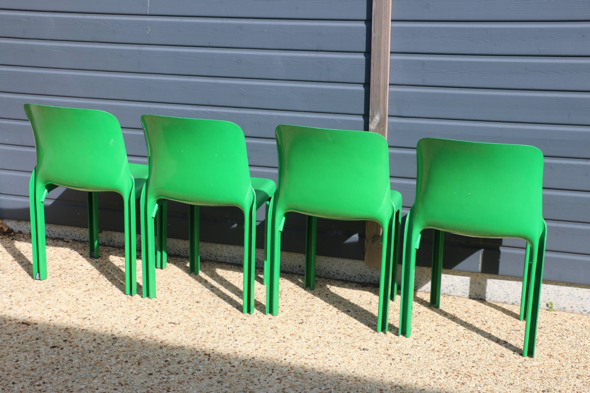 Set of 4 green Selene Magistretti chairs.