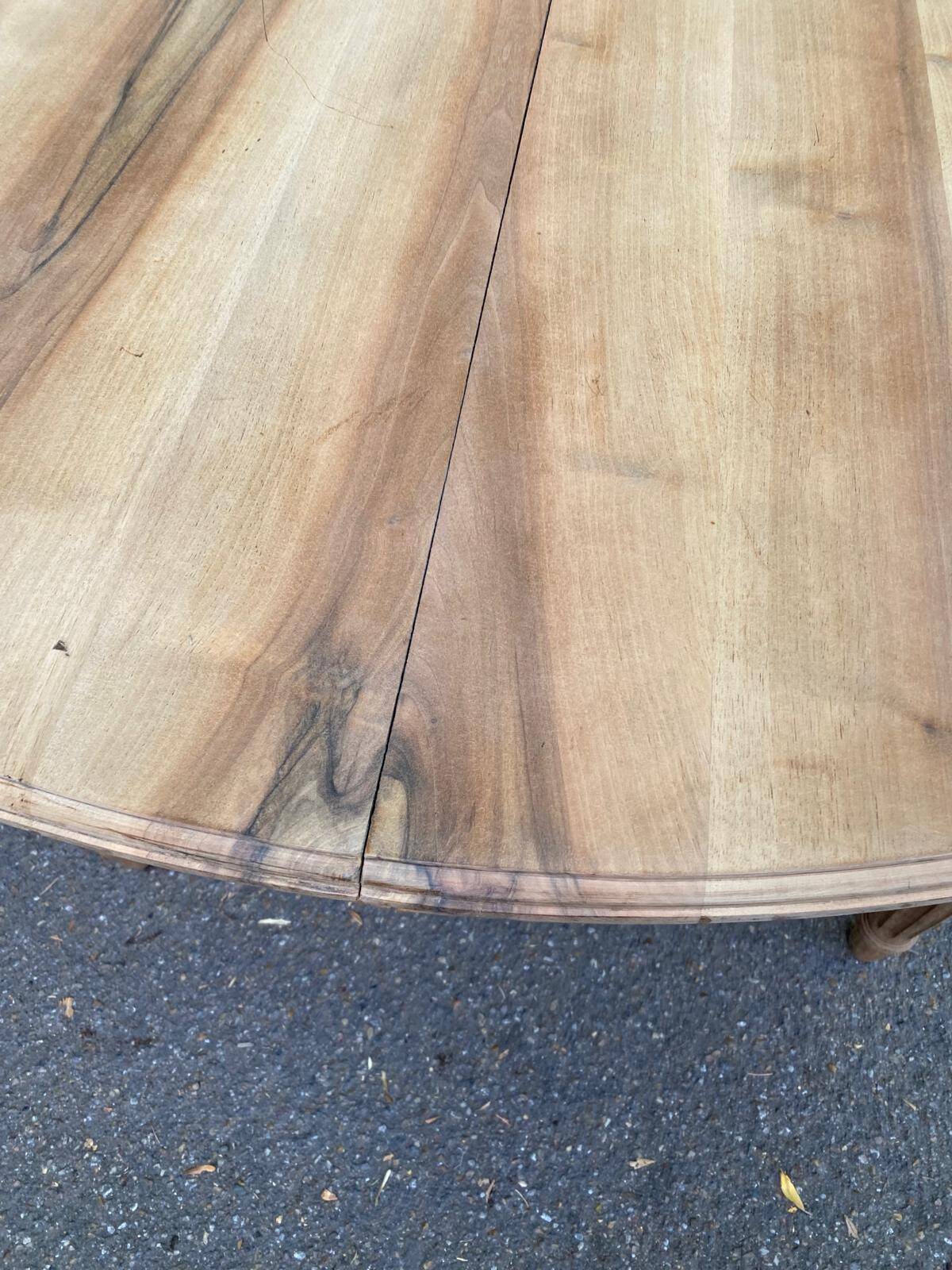 Art Deco round extendable dining table stripped in solid walnut from the 1920s.