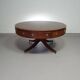 Table basse / table tambour victorienne « Heldense » en acajou avec plateau en cuir sur roulettes en laiton. Années 1980