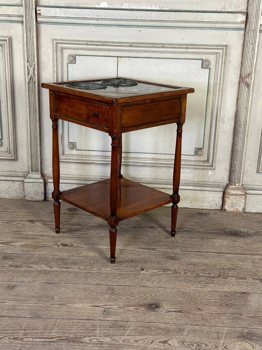Refreshment table in mahogany, grey marble top, two zinc buckets, 18th century.