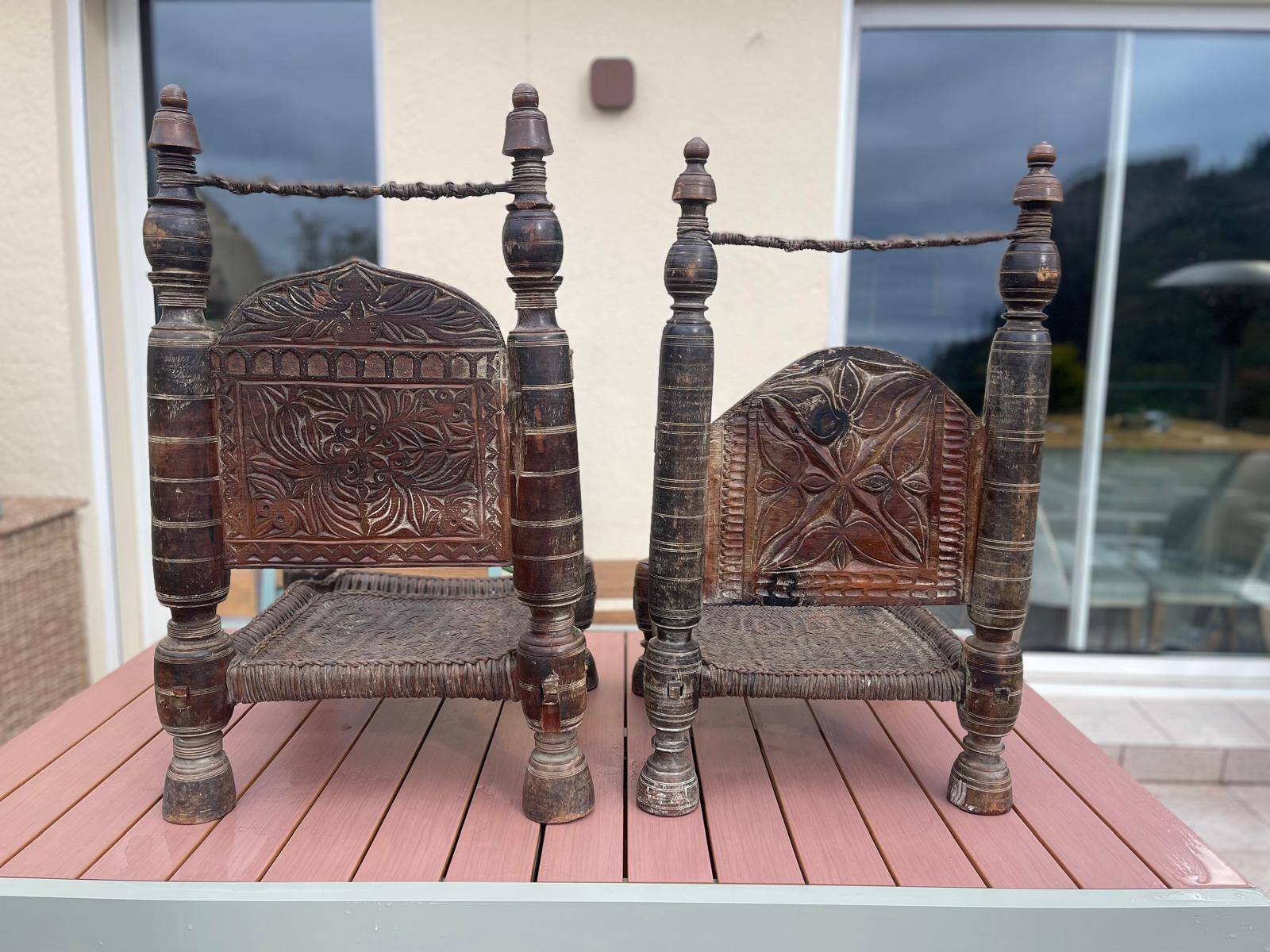Pair of antique traditional Indian carved wooden chairs