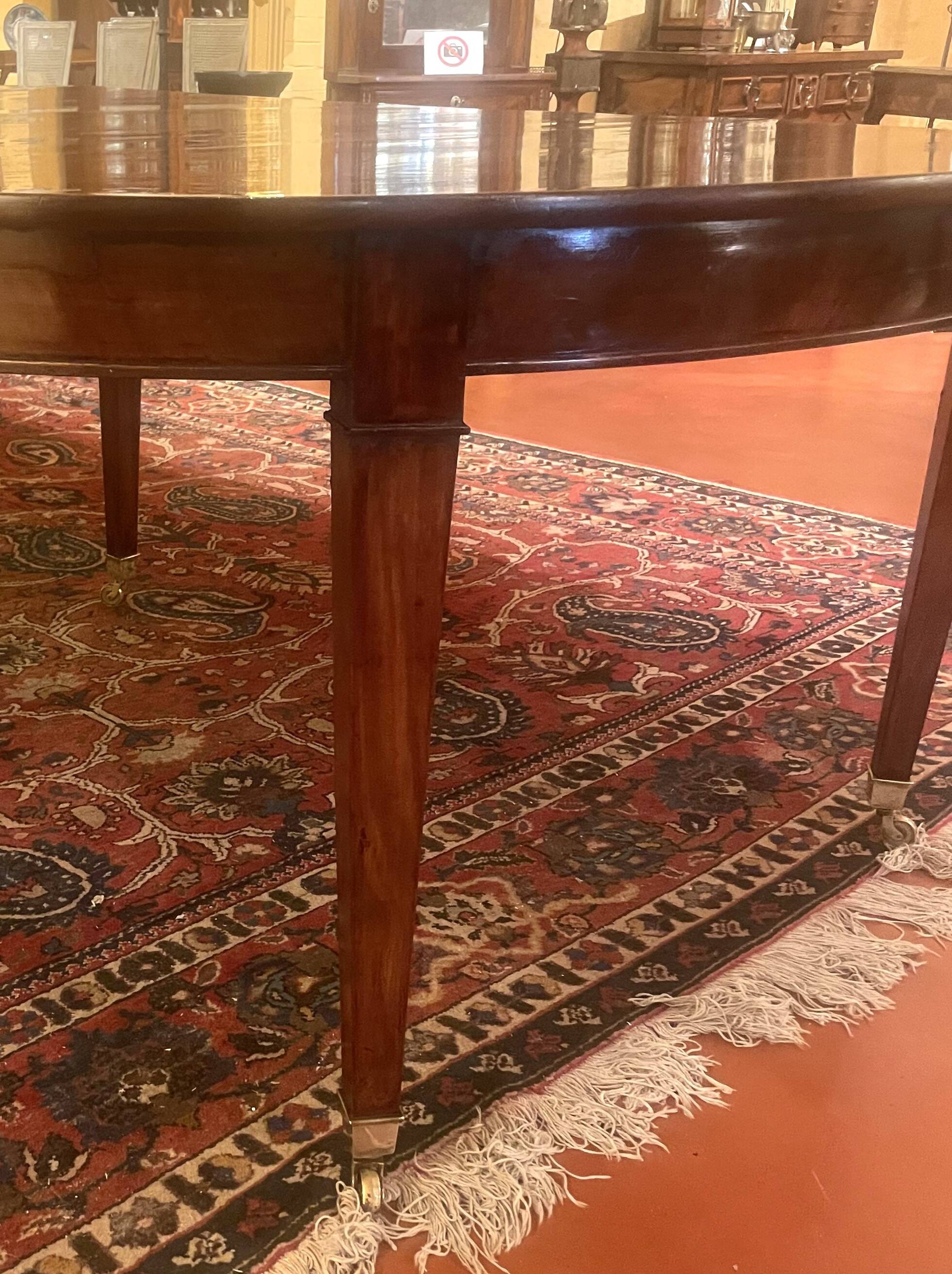 Extensible dining table from the Louis XVI period in mahogany with a banded top.