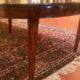 Extensible dining table from the Louis XVI period in mahogany with a banded top.