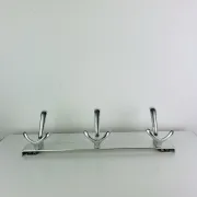 Wall-mounted coat rack, strip of 3 aluminium hooks from the 1960s.