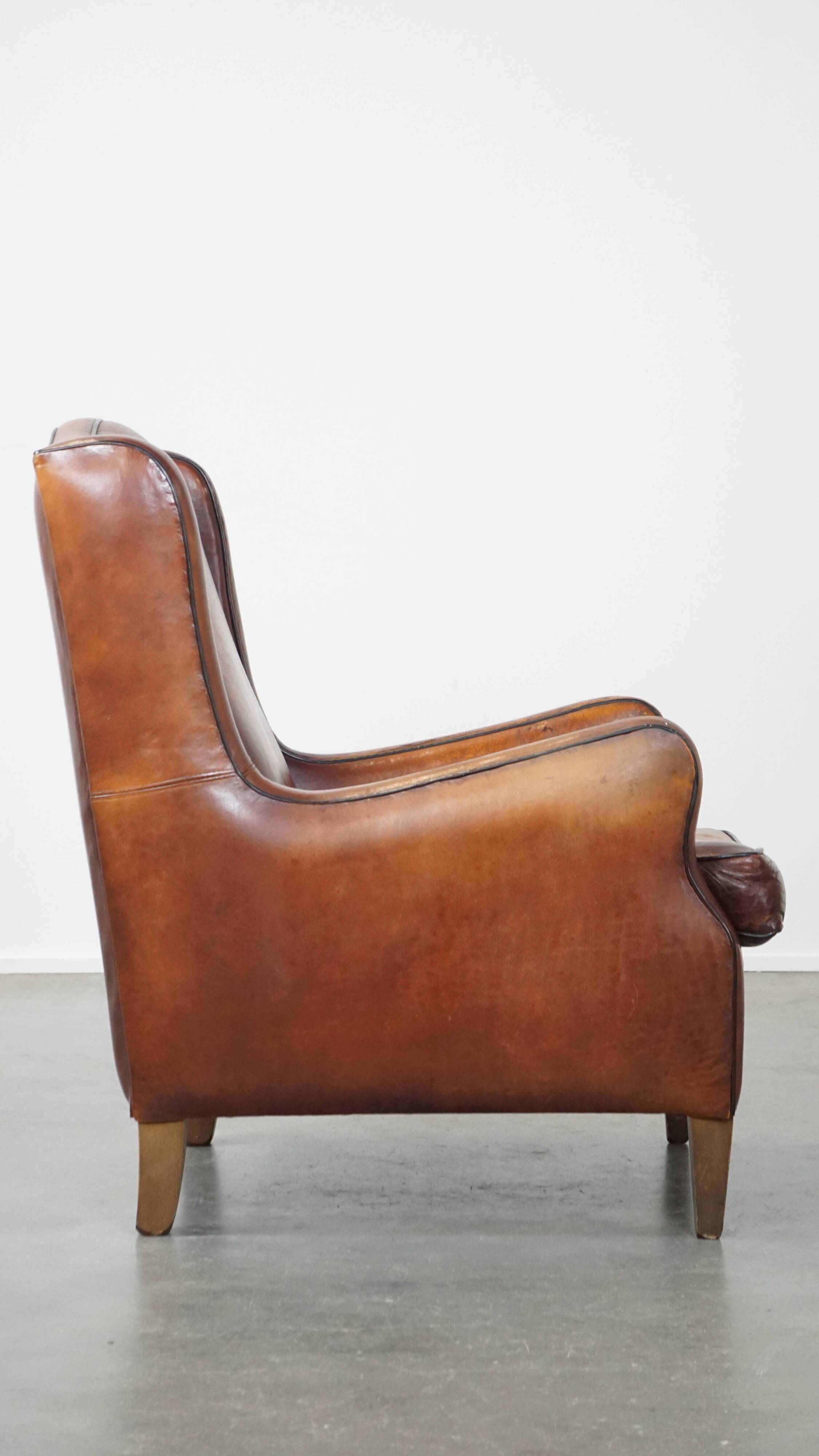 Vintage sheepskin leather armchair finished with black piping