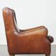 Vintage sheepskin leather armchair finished with black piping