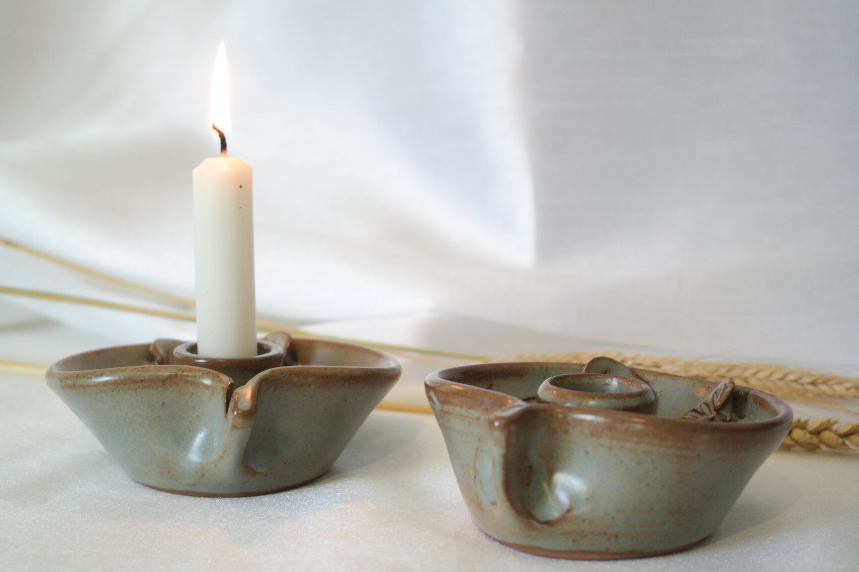Pair of cellar rat candle holders in glazed sandstone