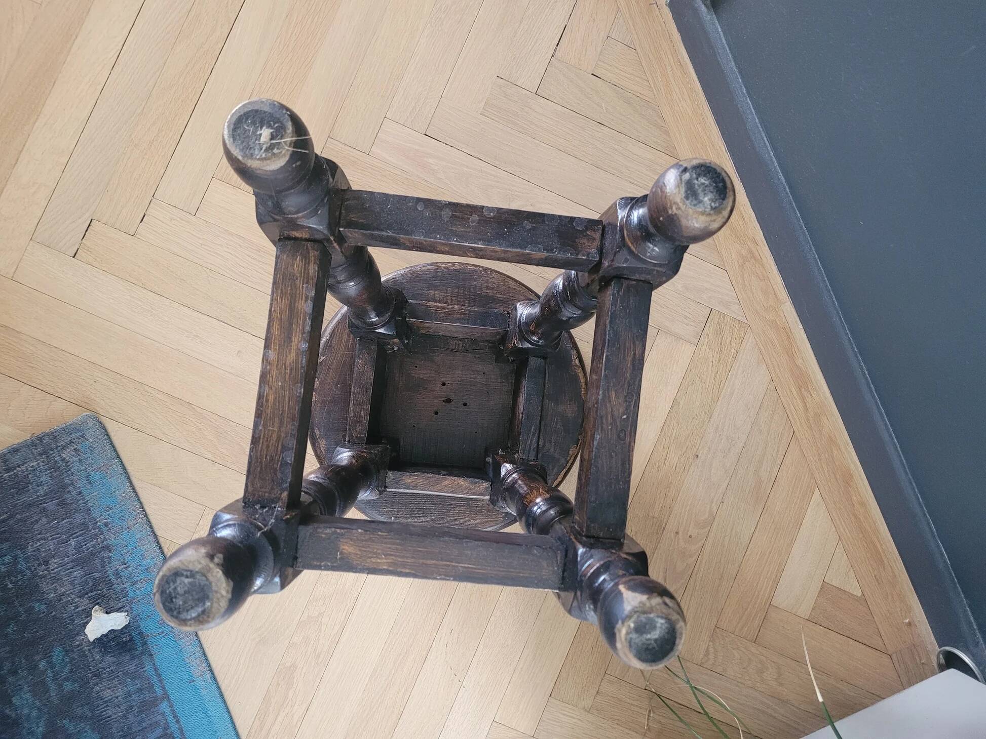 Antique wooden stool with turned legs.