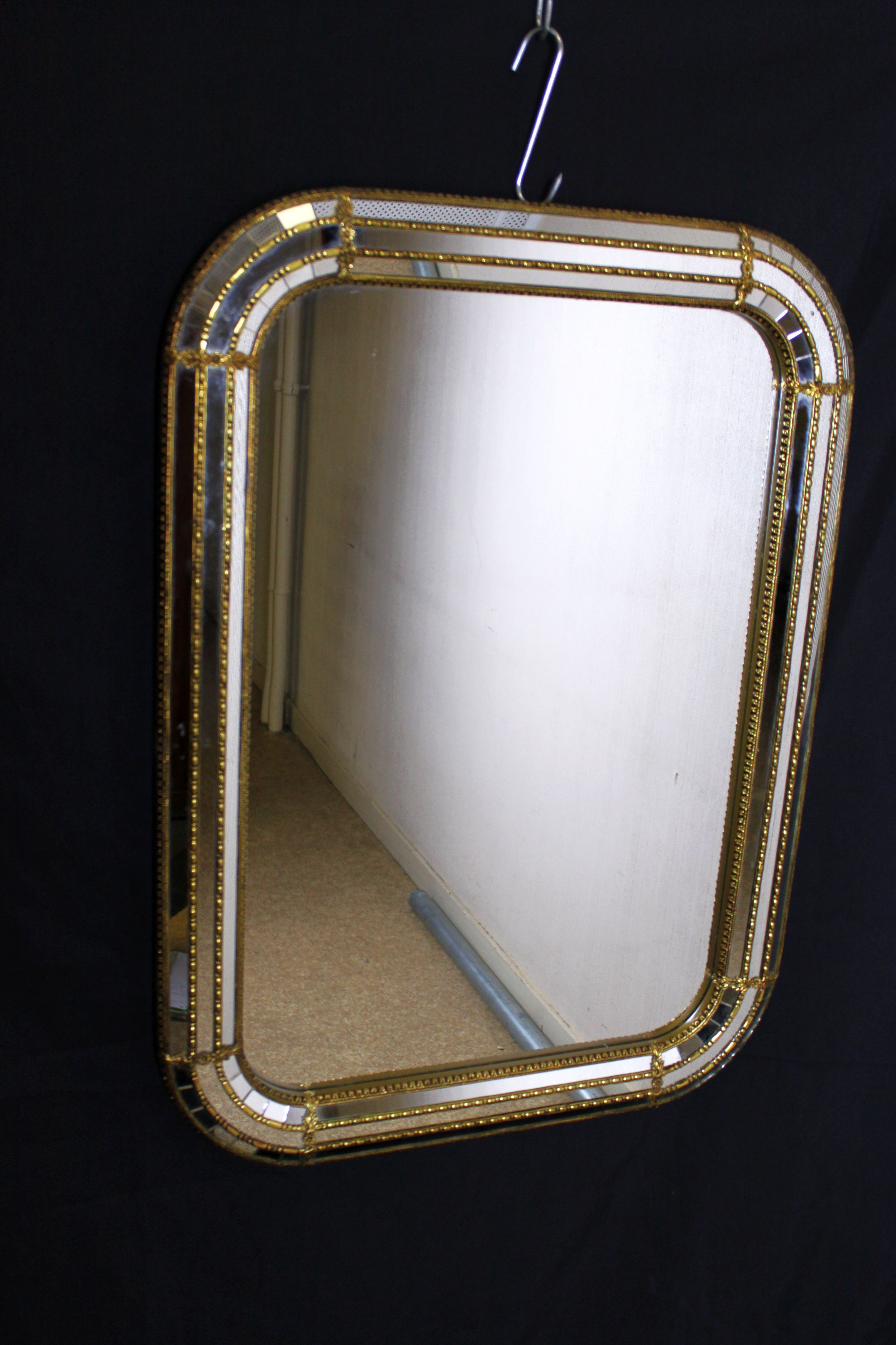 Faceted mirror and gold brass pare closes