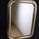 Faceted mirror and gold brass pare closes