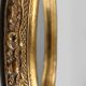 French Baroque style oval mirror in gilded wood with floral decorations