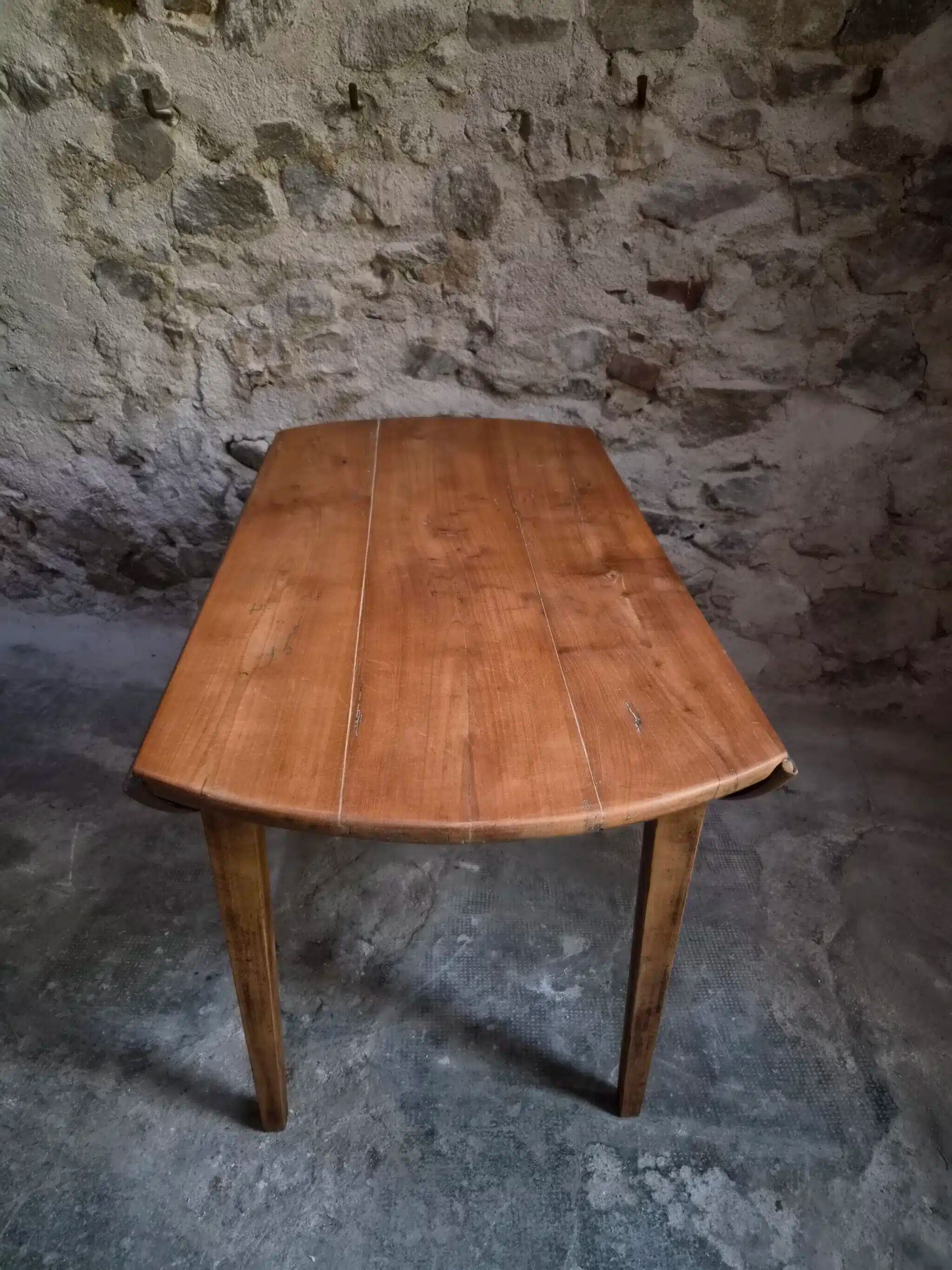 Rustic French antique dining table, drop-leaf table in cherry wood, circa 1900.