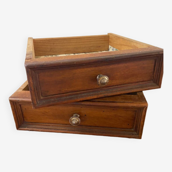 2 wooden drawers with chiseled brass knob.