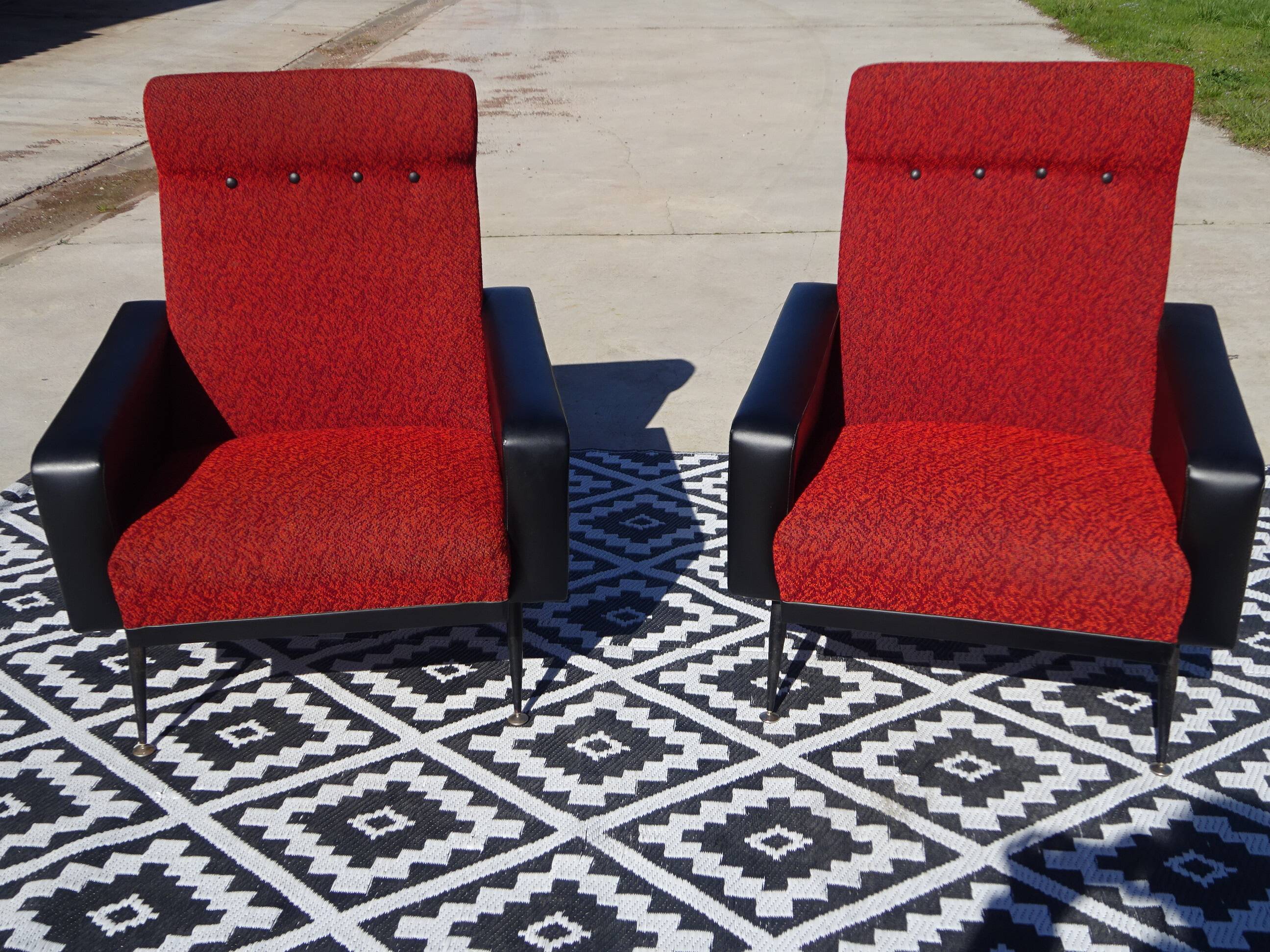 Vintage armchairs in red and black faux leather, the pair.
