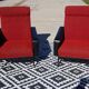 Vintage armchairs in red and black faux leather, the pair.