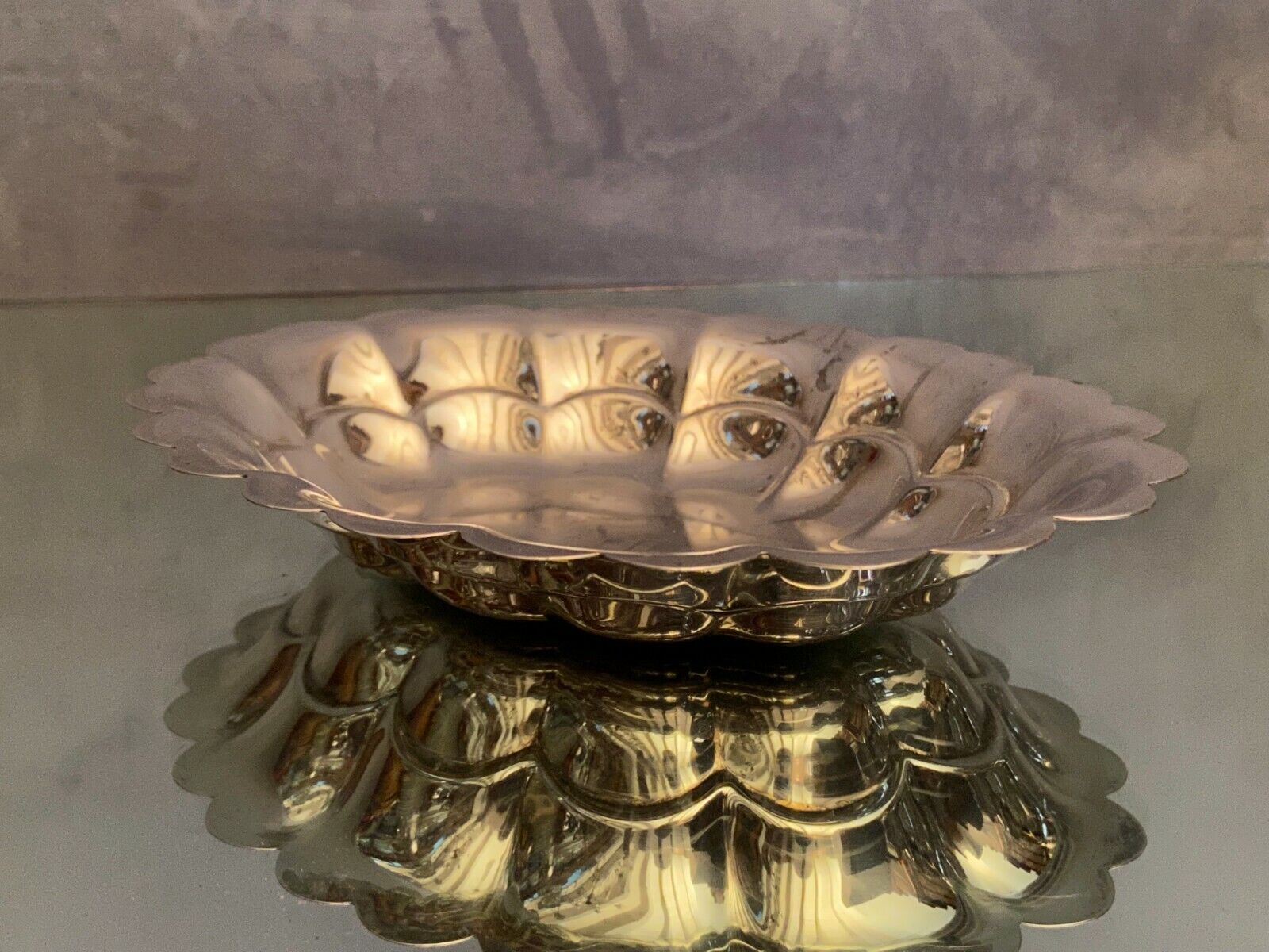 Oval-shaped polylobed metal cup with silver patina engraved with the letter D