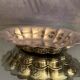 Oval-shaped polylobed metal cup with silver patina engraved with the letter D