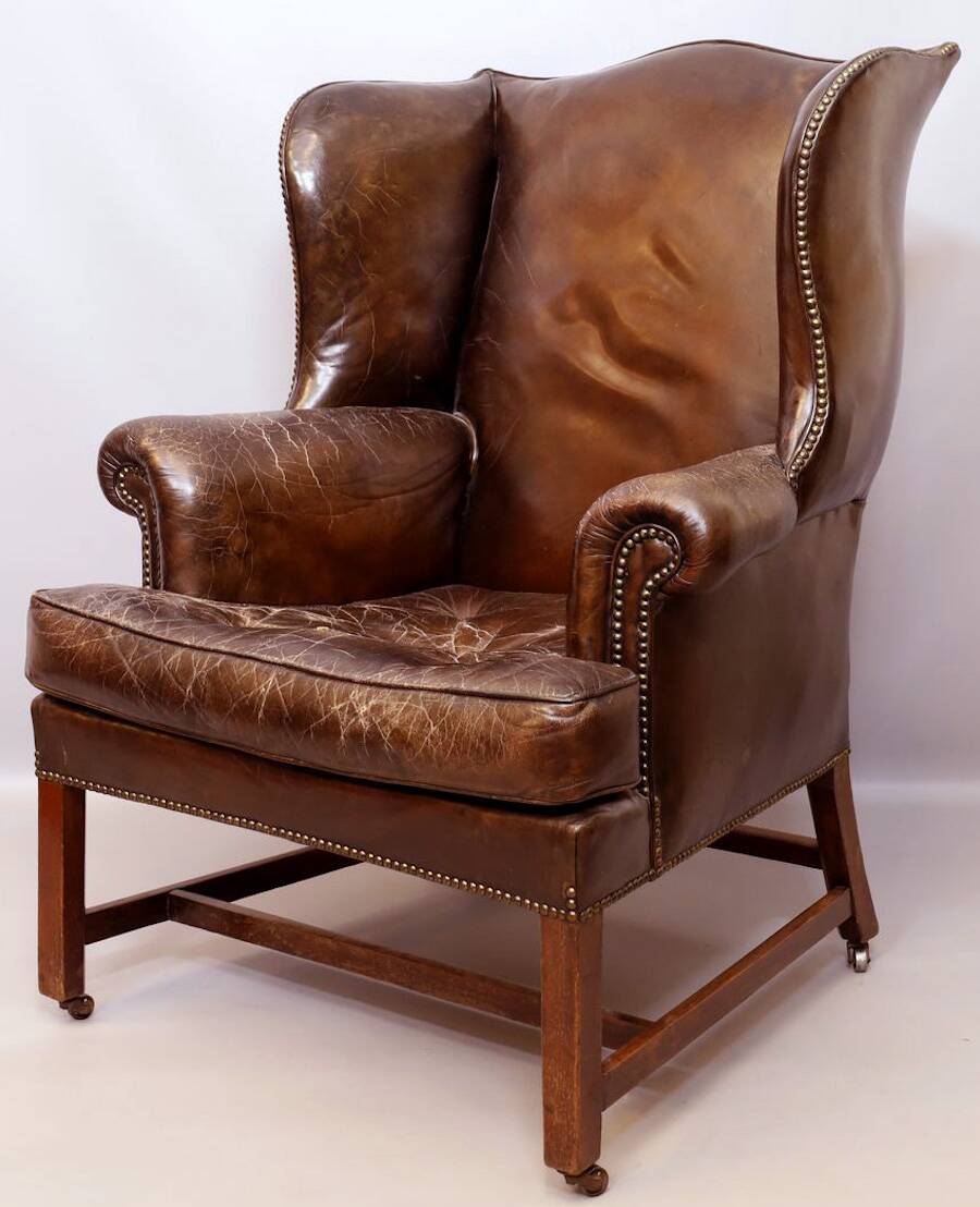 Wingback armchair in dark brown patinated leather, 1970s