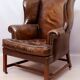 Wingback armchair in dark brown patinated leather, 1970s