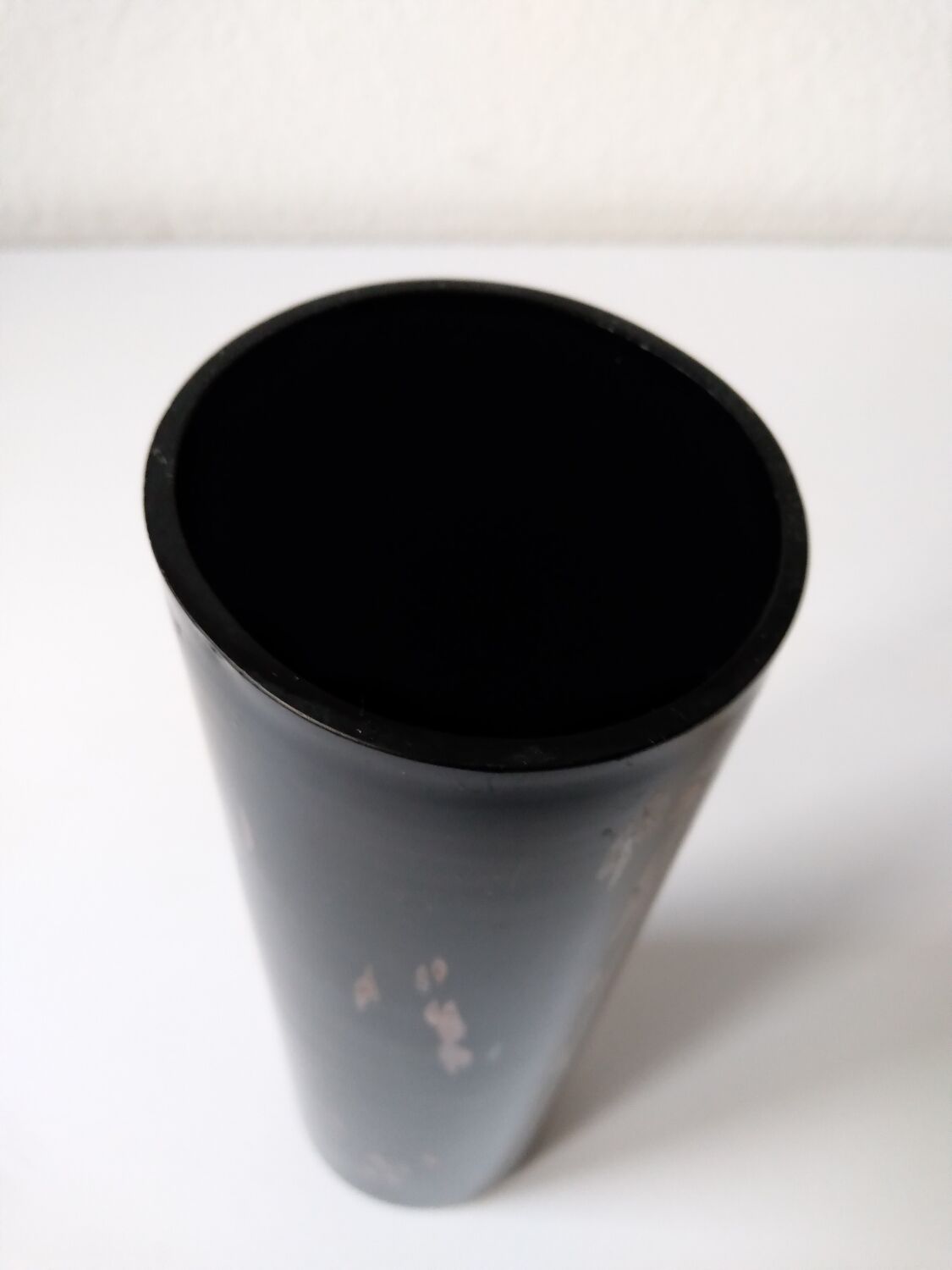 Black opaque glass vase with minimalist style copper inlays