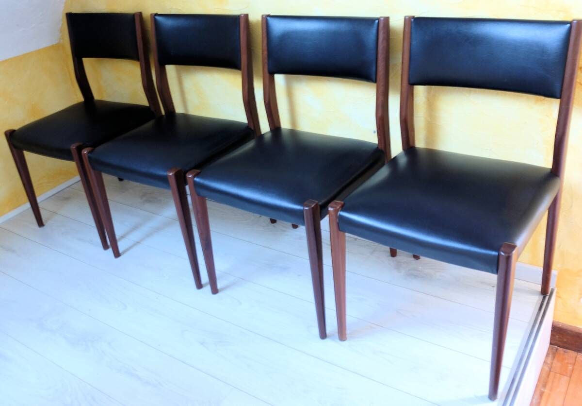 Four antique Scandinavian-style chairs made of solid wood and faux leather.