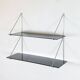 Mid-century vintage shelf in a loop shape, black glass and metal.