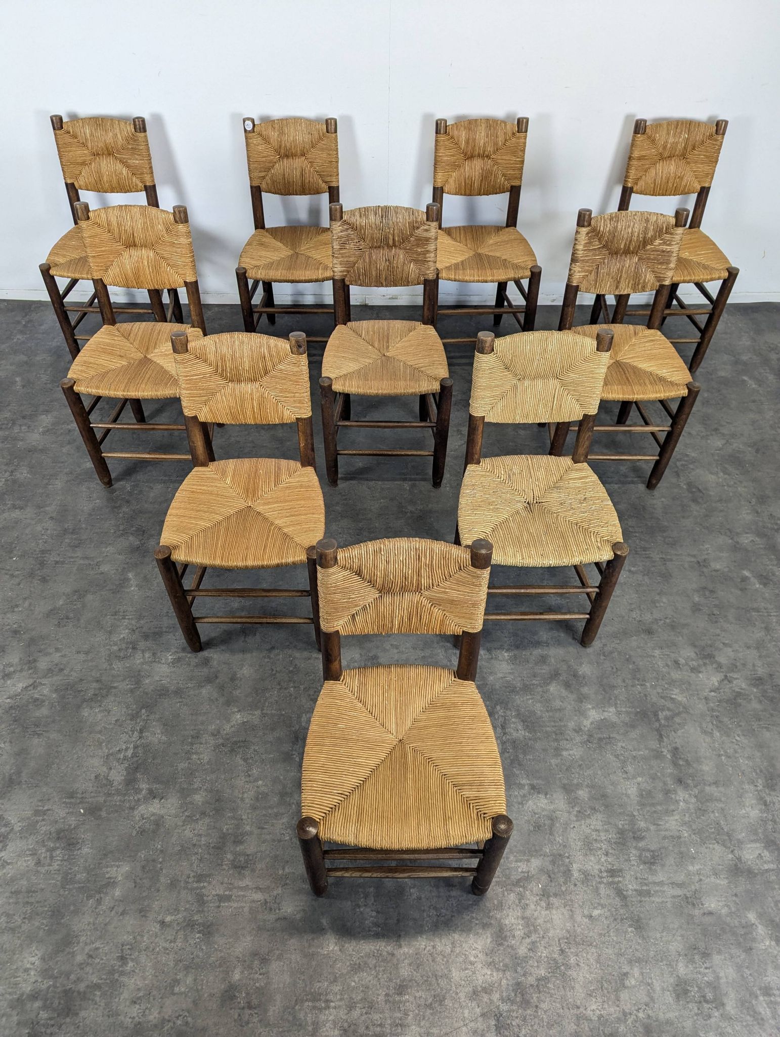 Set of 10 Bauche model chairs by Charlotte Perriand, circa 1960.