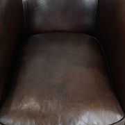 Stylish and sturdy dark brown club armchair made of sheepskin leather