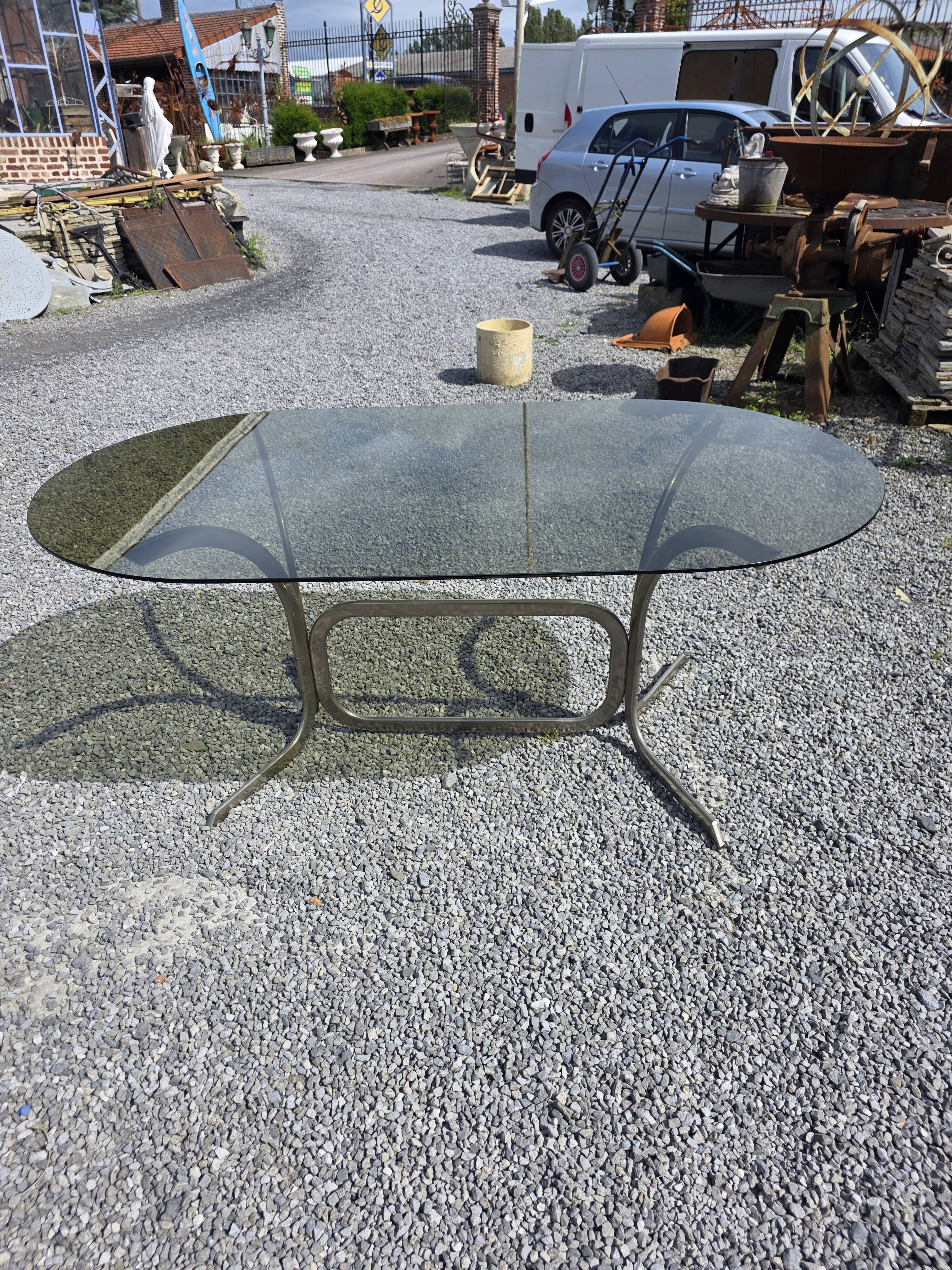 Silver metal table with smoked glass top from the 1970s.