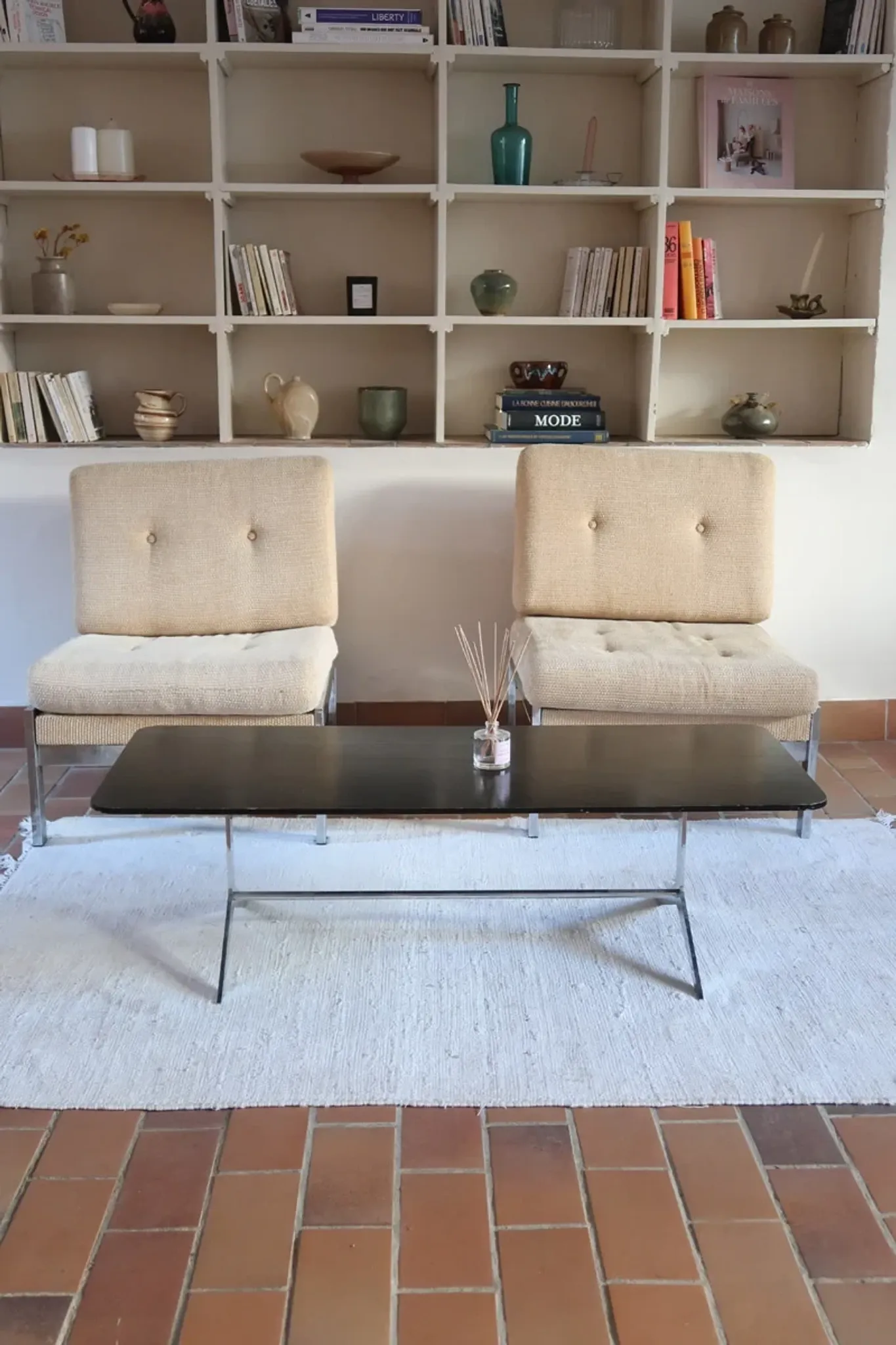 70s design coffee table with a black top and steel legs.