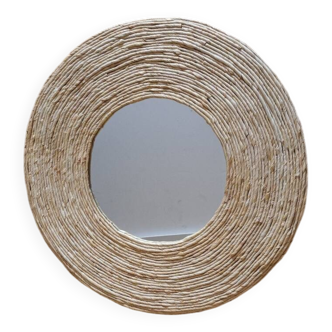 Round mirror surrounded by corn rope