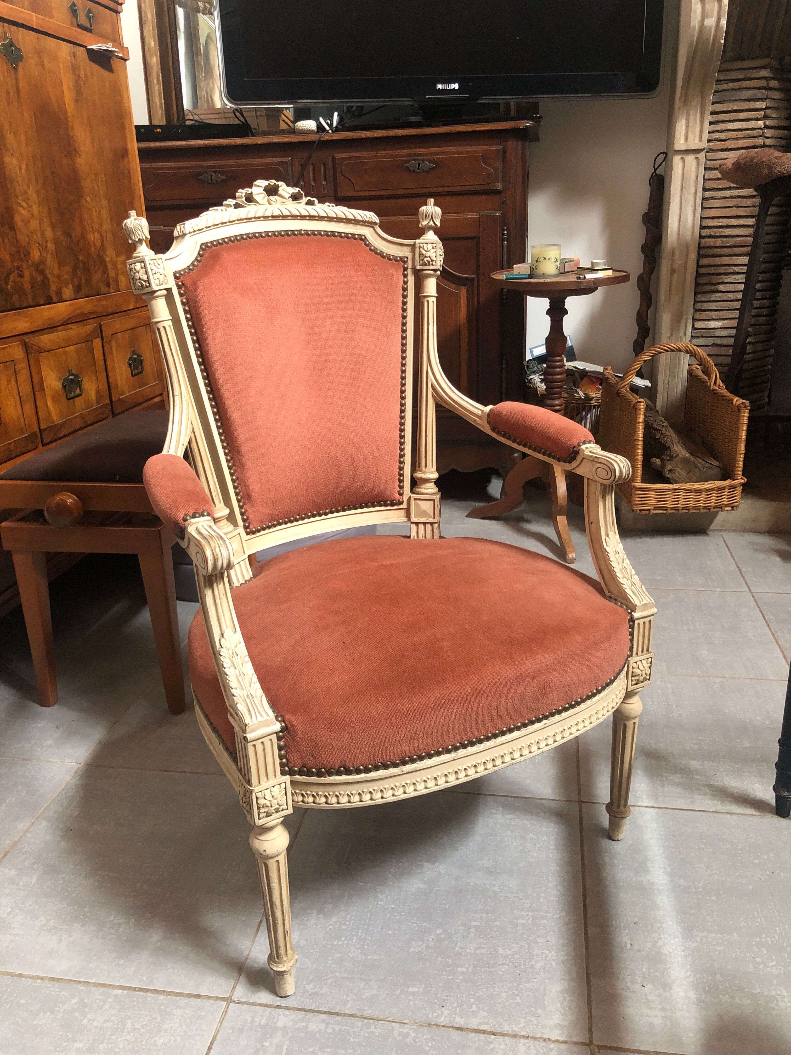 Patinated armchair in Louis XVI style