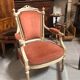 Patinated armchair in Louis XVI style