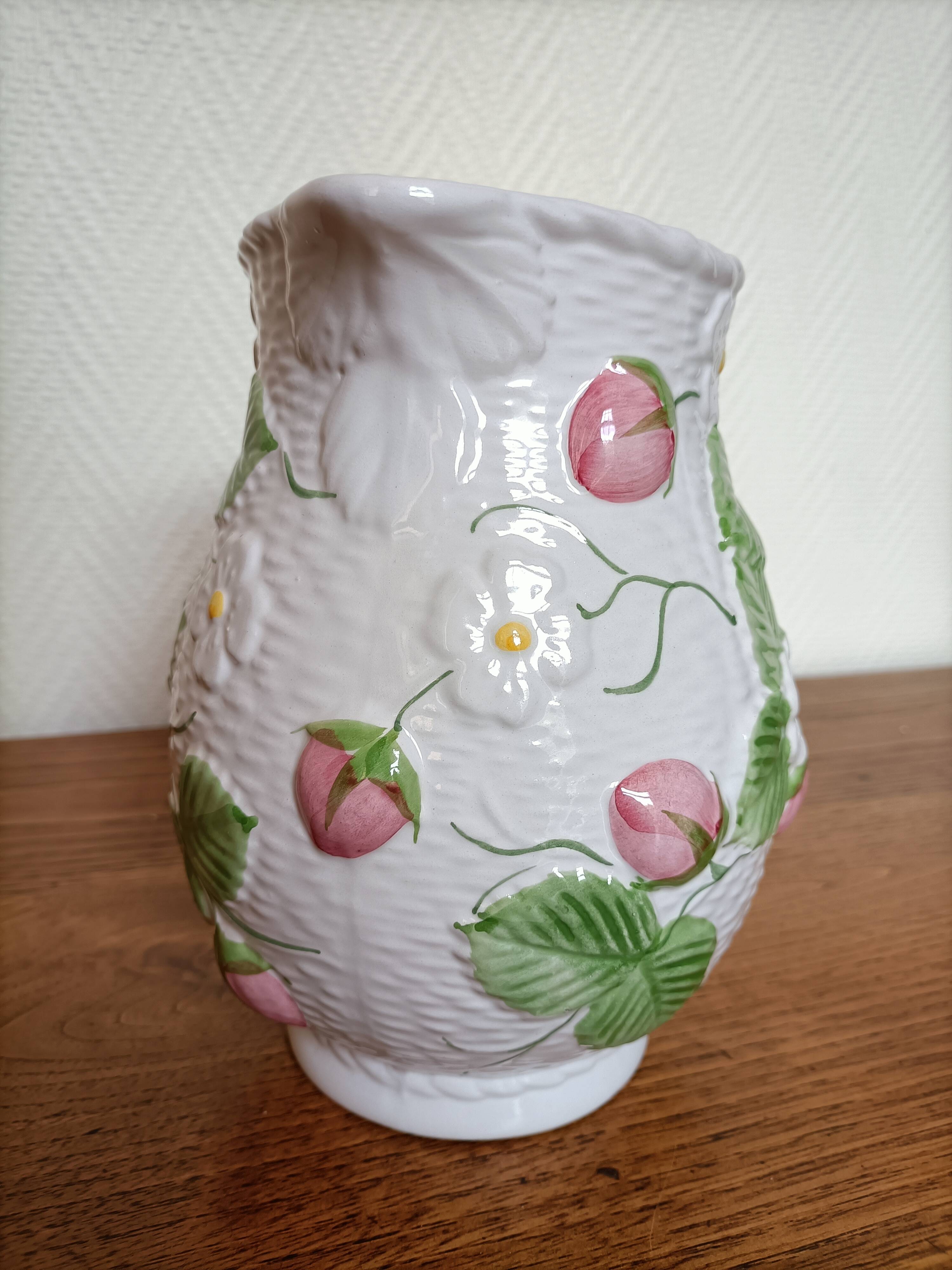 Barbotine pitcher with pastel flower decoration