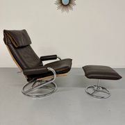 Vintage leather reclining armchair and its 1970s designer ottoman.