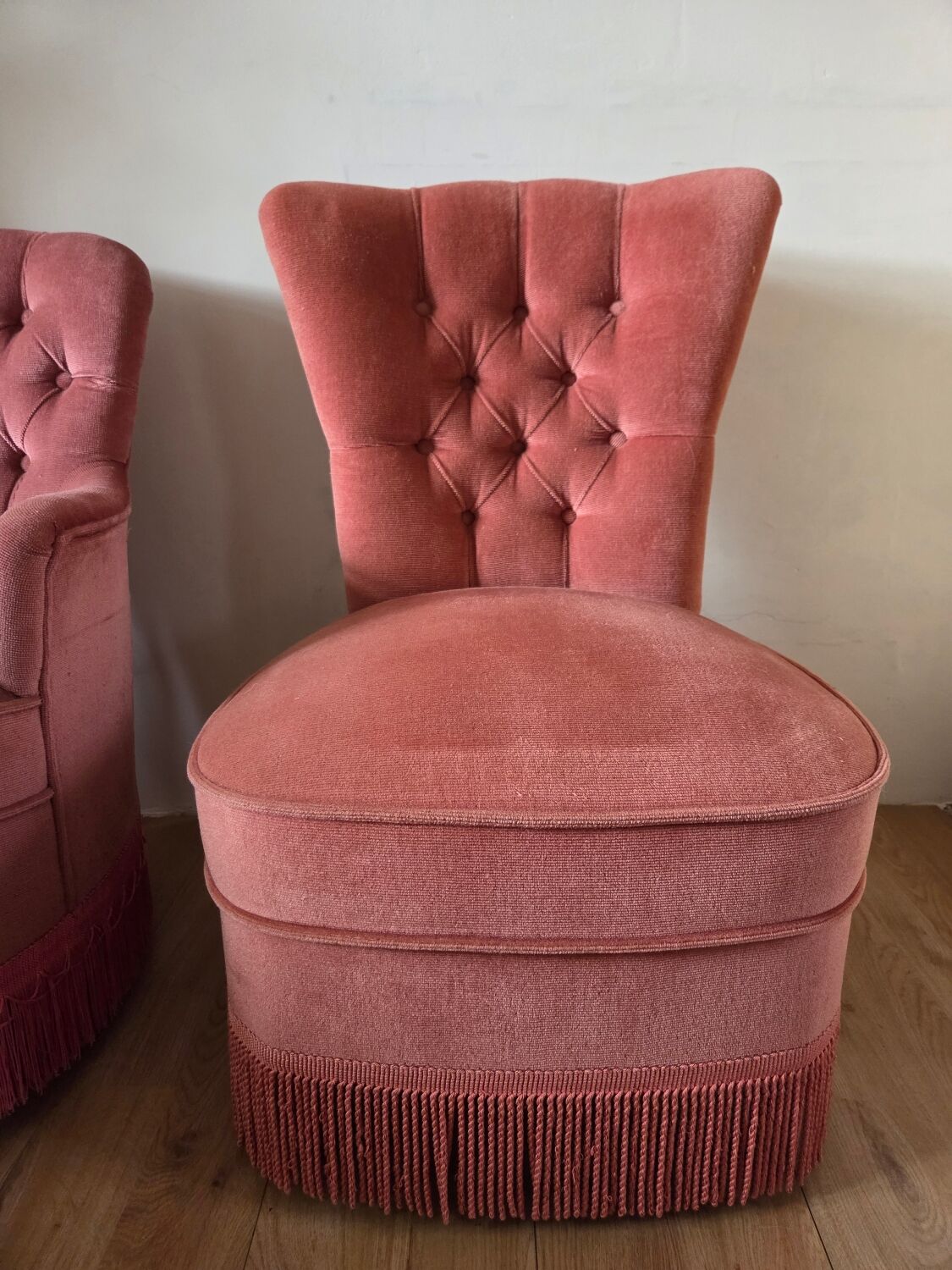 A pair of small tub chairs.