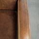 Sheepskin armchair in a light cognac colour with matching piping