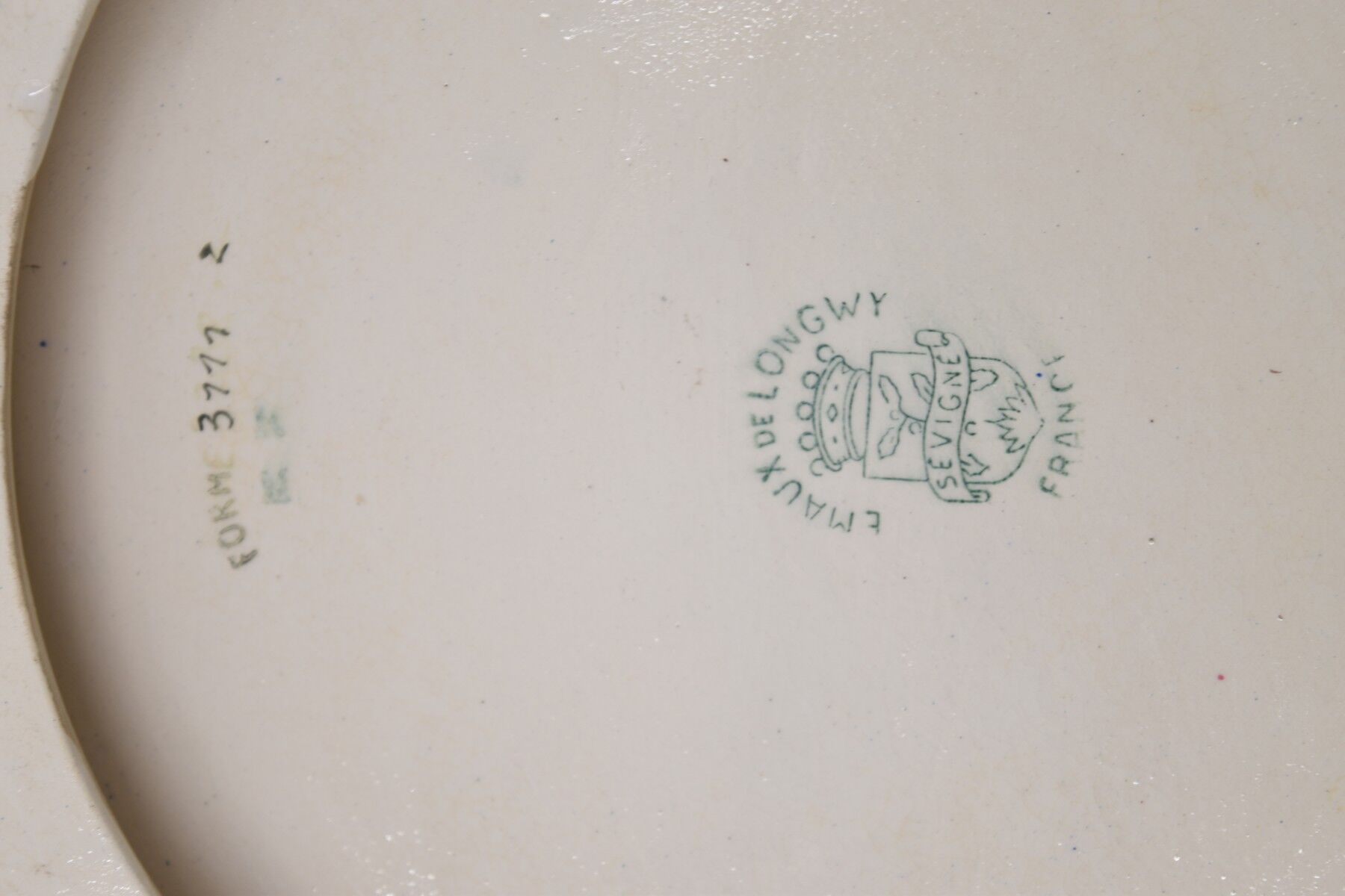 A flat bottom and two enamel bottle bottoms of Longwy