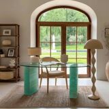 Solid glass desk with a half-moon top.