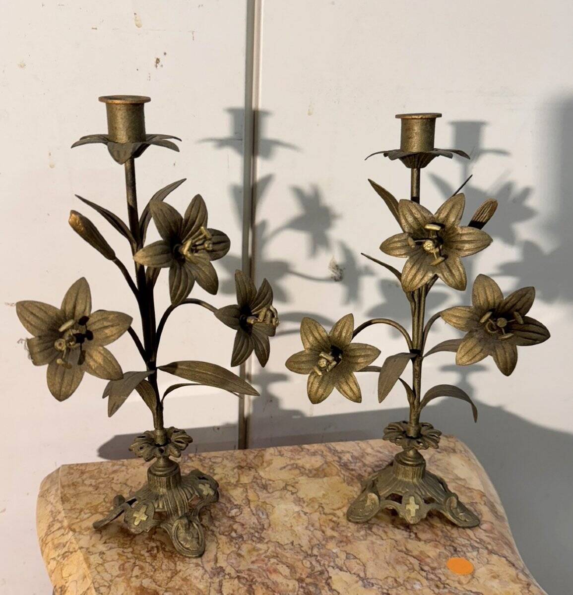 Pair of church candlesticks in bronze with floral decorations.