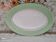 Oval plate with a light green rim and golden frieze, Cafés Lemaire.